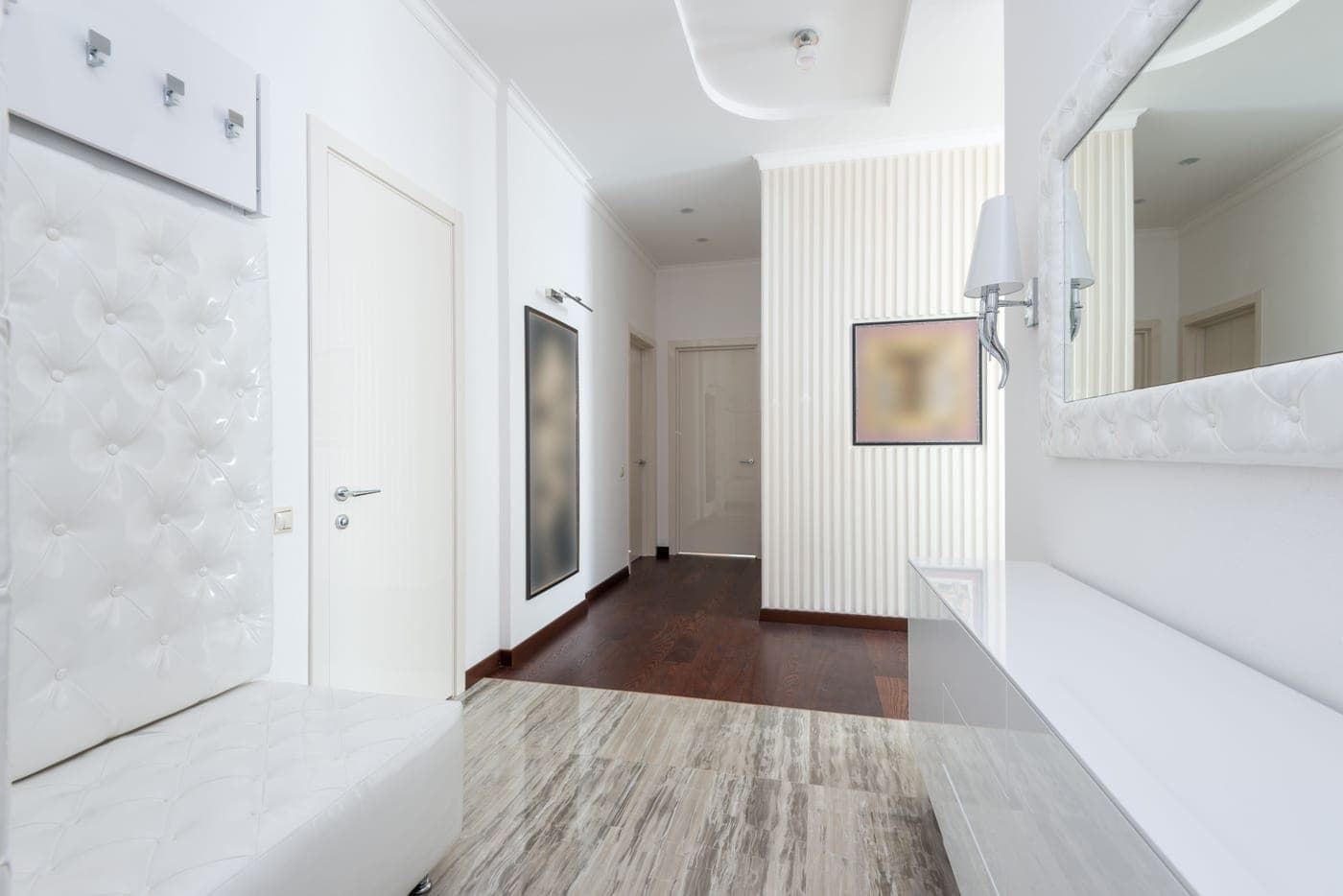A narrow hallway with a slim bench against one wall